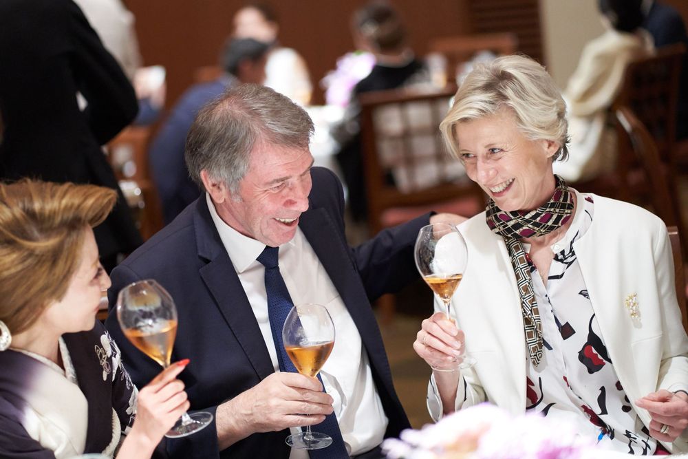 Alexandra Pereyre de Nonancourt sitting enjoying champagne and conversation at a social gathering.