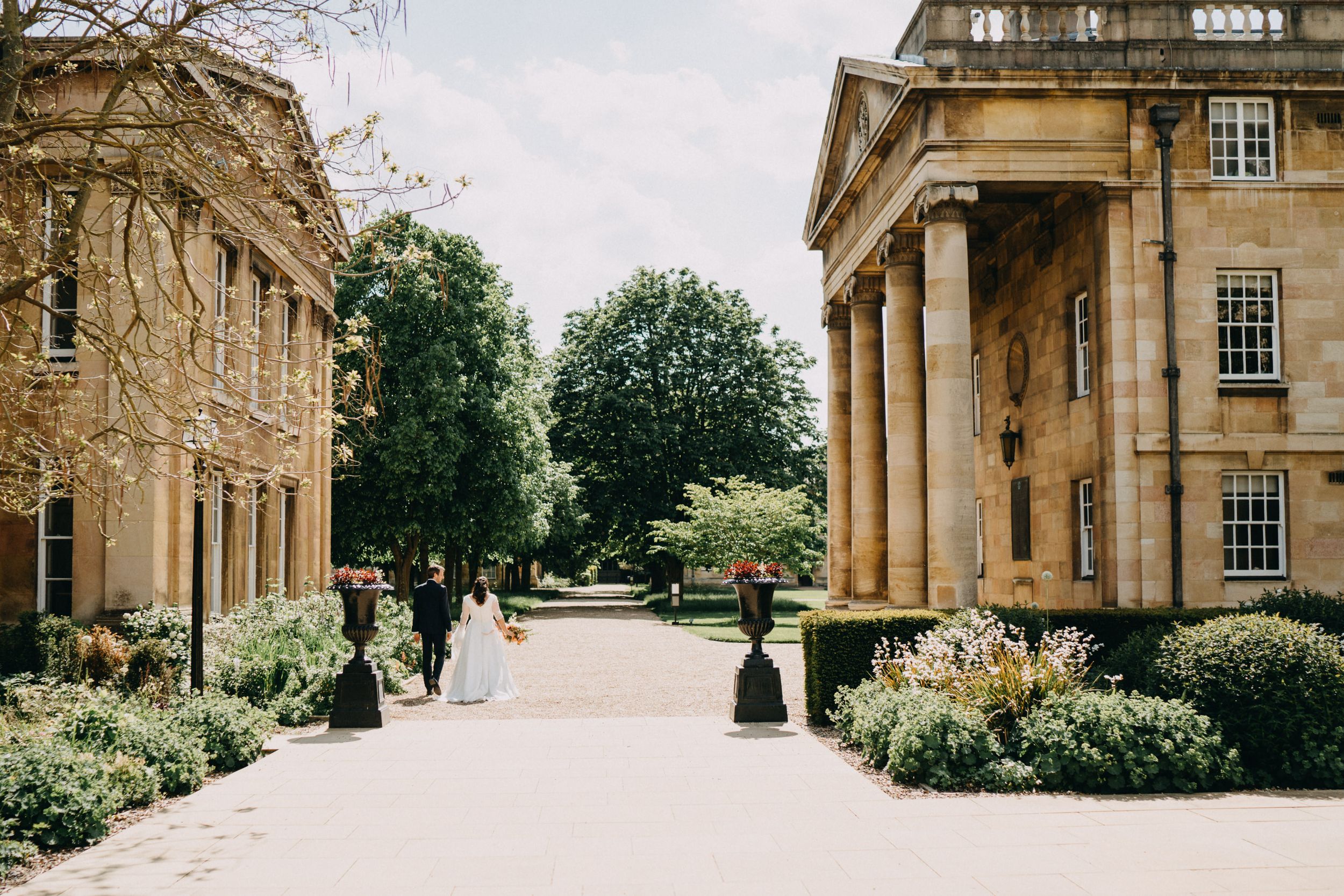 View of a classical architecture walkway between two grand buildings of Downing College Cambridge.