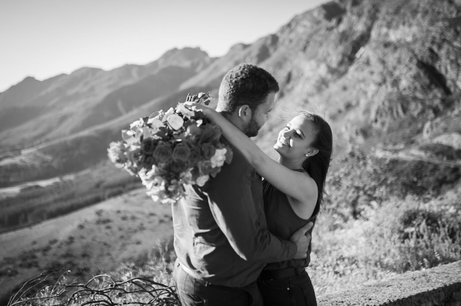 Couple embracing while enjoying scenic mountain views on an autumn day.