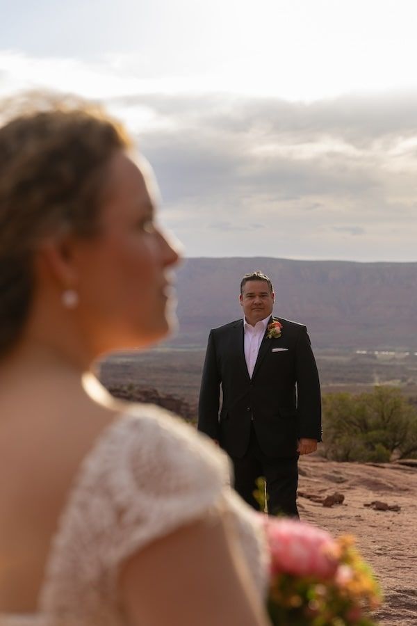 couple in a desert landscape posing for photos at castle valley