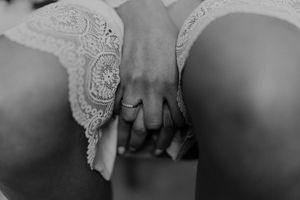 Detail shot of lace bridal lingerie during wedding morning prep — intimate and elegant storytelling for destination wedding in Portugal.