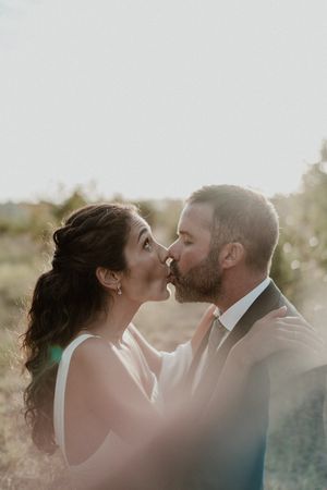 Bride sticking her tongue out while holding her bouquet — bold and alternative wedding portrait in Portugal