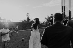 Bride and groom walking through the gardens of The Astoria — emotional portrait with golden light in Porto
