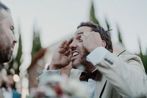 Unfiltered moment of two guests in a deep hug, drink in hand — cinematic cocktail storytelling at The Astoria