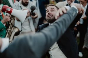 Guest dancing with a drink in hand before dinner — cocktail chaos at The Astoria wedding party