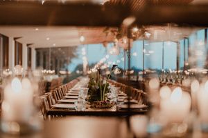 Boho-inspired table decor with long wooden tables and wild florals — wedding reception setup at The Astoria by Histórias com Alma