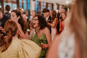 Back-of-head shot of guests jumping together in sync — pulse of the party at The Astoria wedding venue
