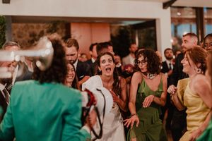 Sweaty, unfiltered dance floor moment with laughter and open mouths — raw joy at The Astoria