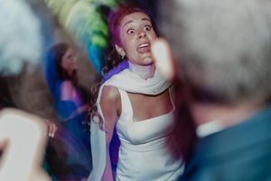 Bride and friends dancing together at the wedding reception