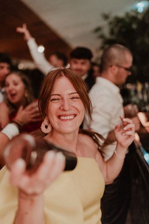 Wedding party in full swing with friends laughing and dancing