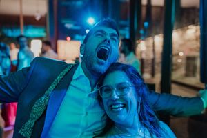 Sweaty, unfiltered dance floor moment with laughter and open mouths — raw joy at The Astoria