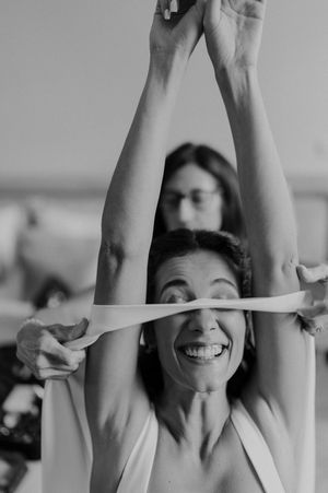Bridesmaids raising hands and laughing during prep — fun and energetic moment before the wedding in Portugal.