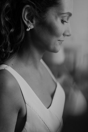 Bride getting ready in soft window light — natural portrait captured before the wedding ceremony in Portugal.