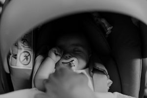 Baby sleeping peacefully in a stroller during a wedding in Portugal — candid family moment at The Astoria venue.