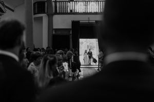 Emotional moment before the ceremony — bride and father waiting at the church entrance during a wedding in Portugal.