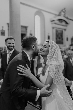 Bride and groom holding hands while exchanging vows at The Astoria wedding venue in Portugal.