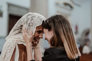 Emotional moment between the bride and a guest — intimate wedding photography in The Astoria gardens, Portugal.