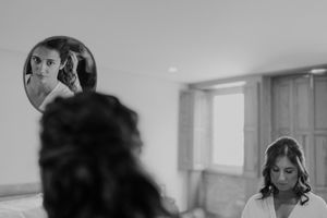 Candid wedding moment of the bride getting ready with bridesmaids in the background — documentary-style photo at The Astoria, Porto.
