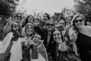 Candid photo of wedding guests pulling funny faces during cocktail hour — fun moments captured at The Astoria in Porto.