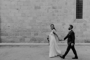 Cinematic shot of the bride and groom walking together after the ceremony — candid Portugal wedding photo at The Astoria.