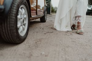 Close-up shot of a bride's elegant white lace shoes - alternative wedding details photography