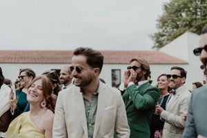 Group of guests making silly faces in a spontaneous photo — alternative portrait style during the wedding day
