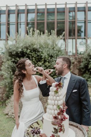 Bride and groom cutting the wedding cake together — emotional and fun moment at The Astoria