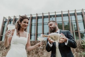 Bride and groom cutting the wedding cake together — emotional and fun moment at The Astoria
