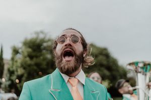 Brass band playing in the garden during cocktail hour — high-energy wedding moment at The Astoria