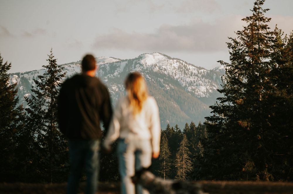Maternity candid photography of couple looking at beautiful mountain views on Vancouver island golden hour light photographer