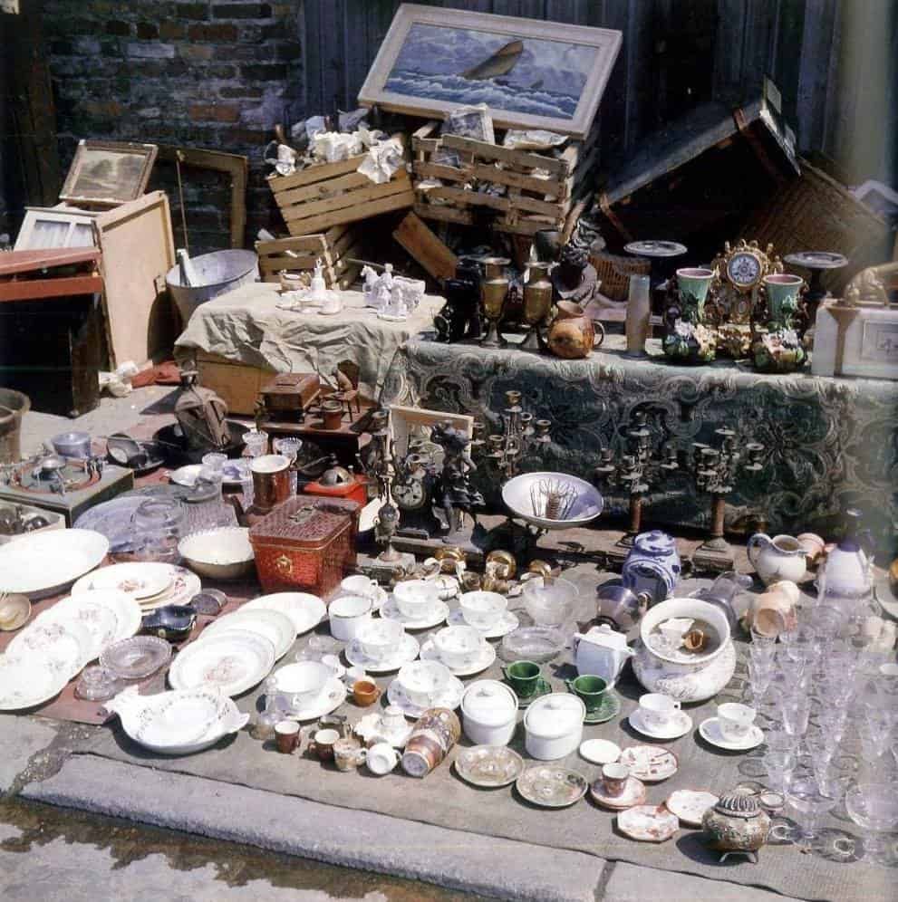 Vintage collectibles and antique dishware displayed at an outdoor market.