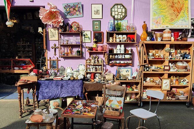 Colorful vintage shop interior with shelves of collectibles and purple walls.