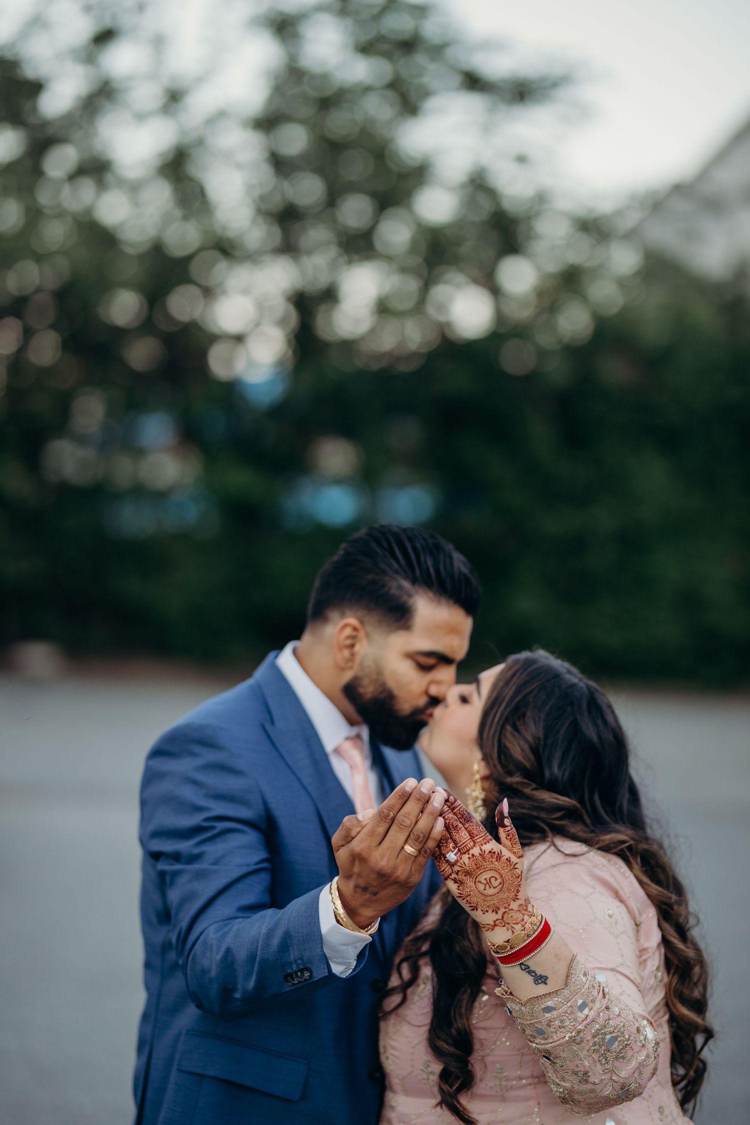 Engagement photograph of a couple kissing and showing there engagement rings.