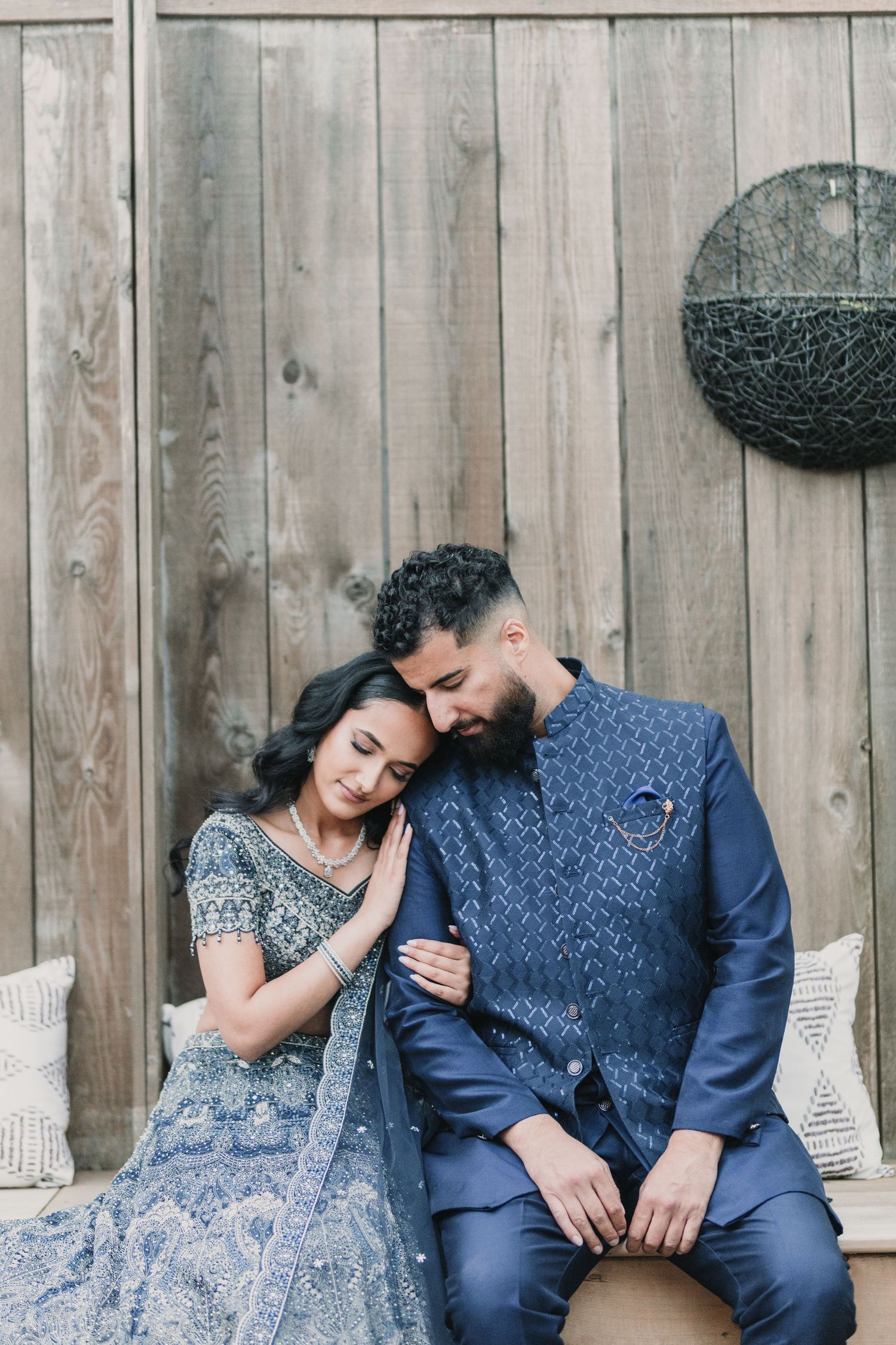 Couple photoshoot of a girl resting her head on guys shoulder.