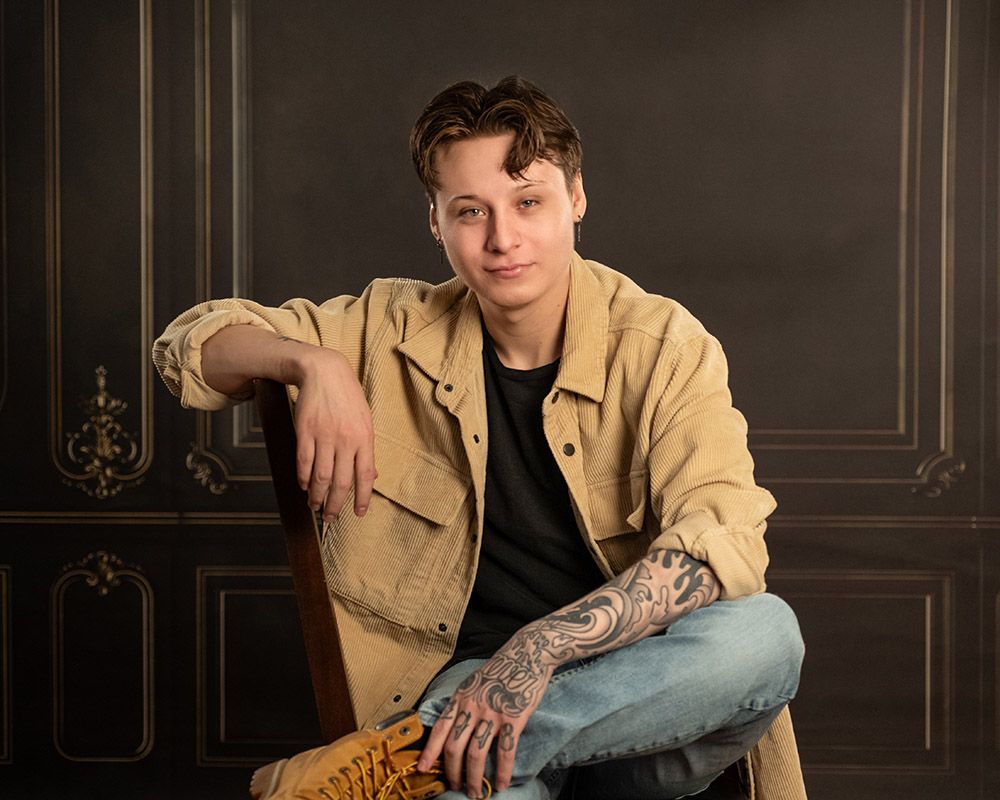 male model portrait on a young man in studio on dark background by headshot photographer luba wold in post falls idaho