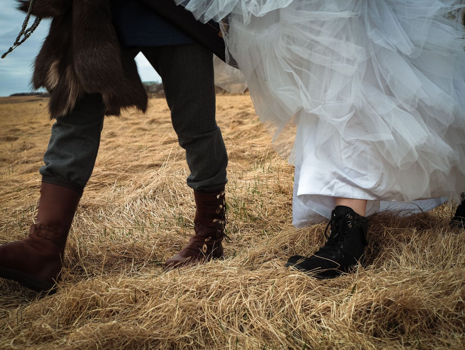 Detailed photo of bride and grooms legs - boots, shoes captured by Copenhagen based wedding photographer Kat Deptula.