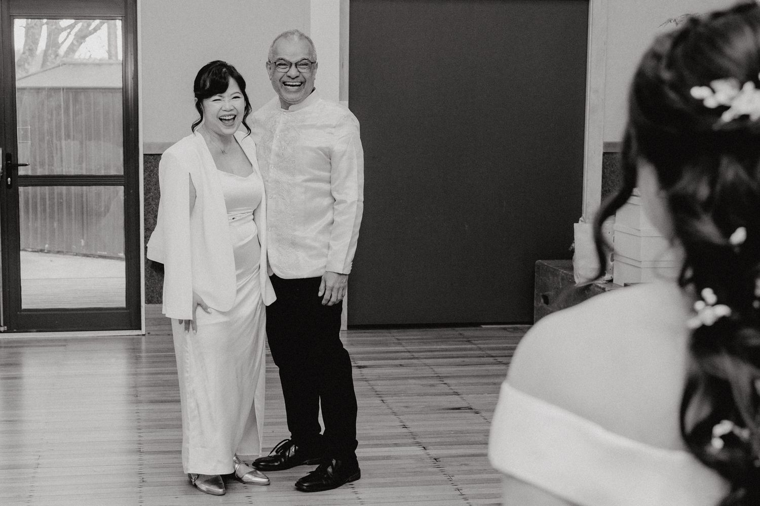 Black and white wedding photo showing couple in formal attire.