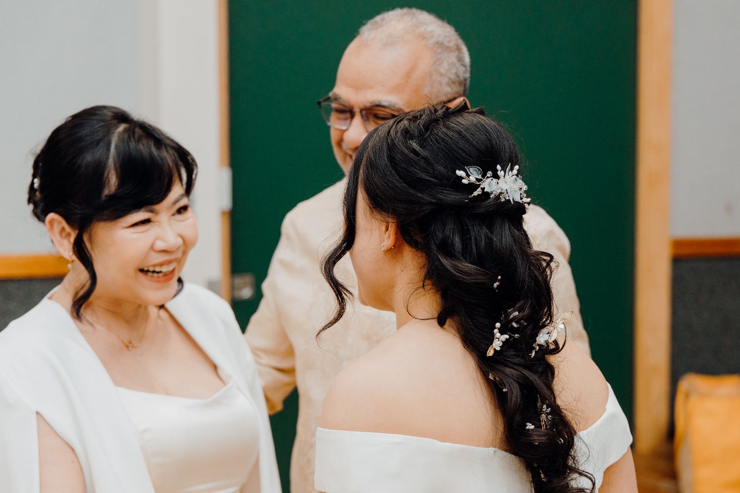 Intimate wedding ceremony moment with white and cream formal attire.