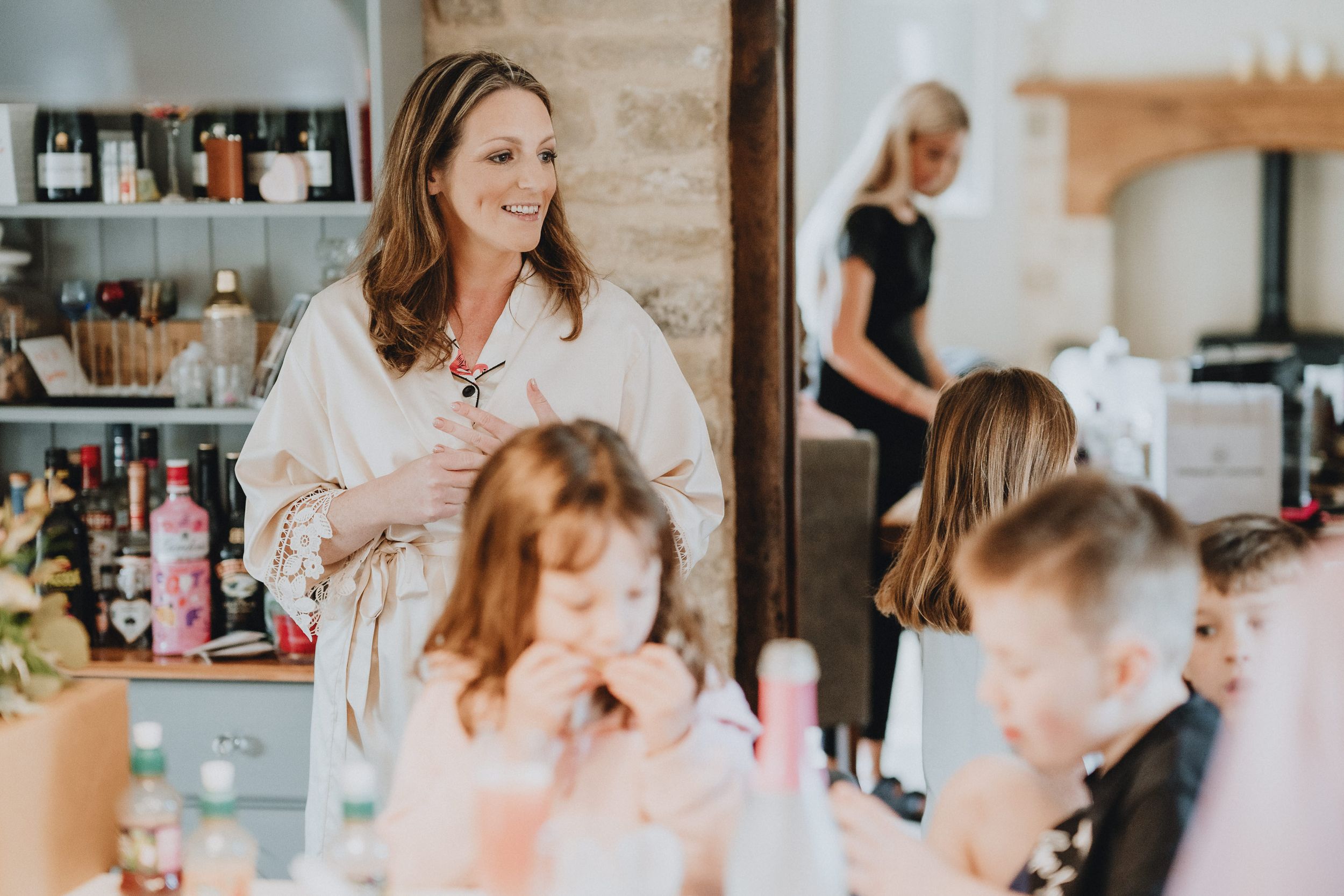 Getting ready in a bridal suite with white robes and hair styling preparations at a salon.