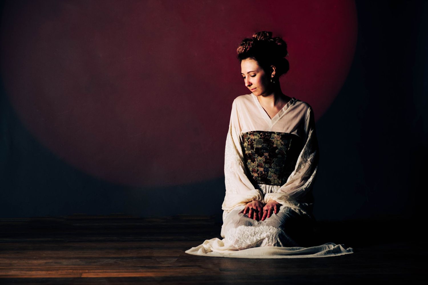Dramatic portrait in traditional Japanese geisha style against dark background.