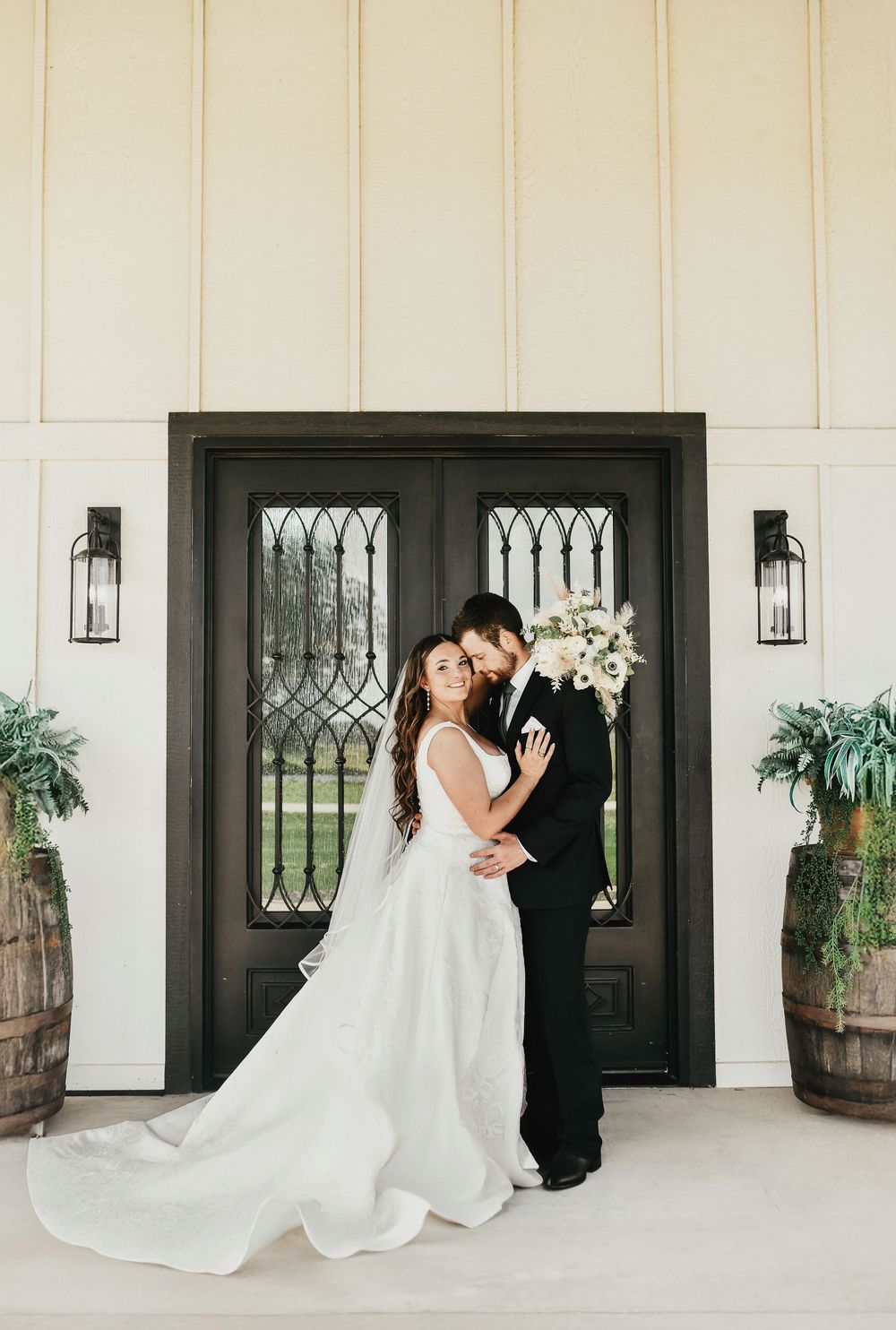 Romantic wedding couple photo with shiplap barn backdrop