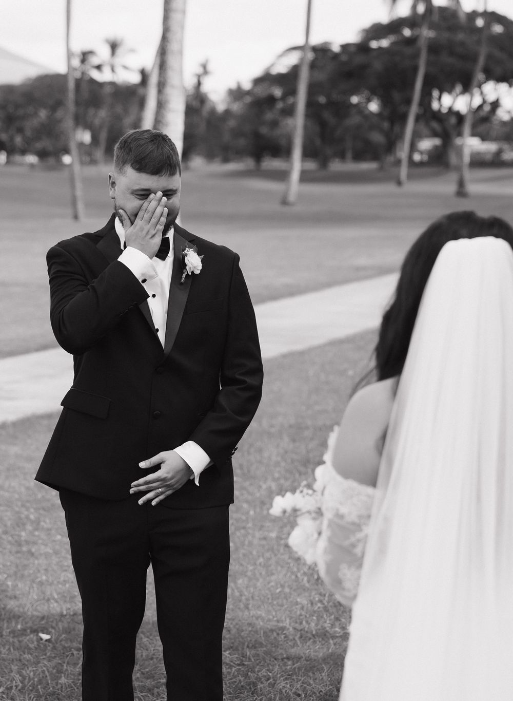 Black and white candid wedding moments captured outdoors showing tender interactions between newlyweds.