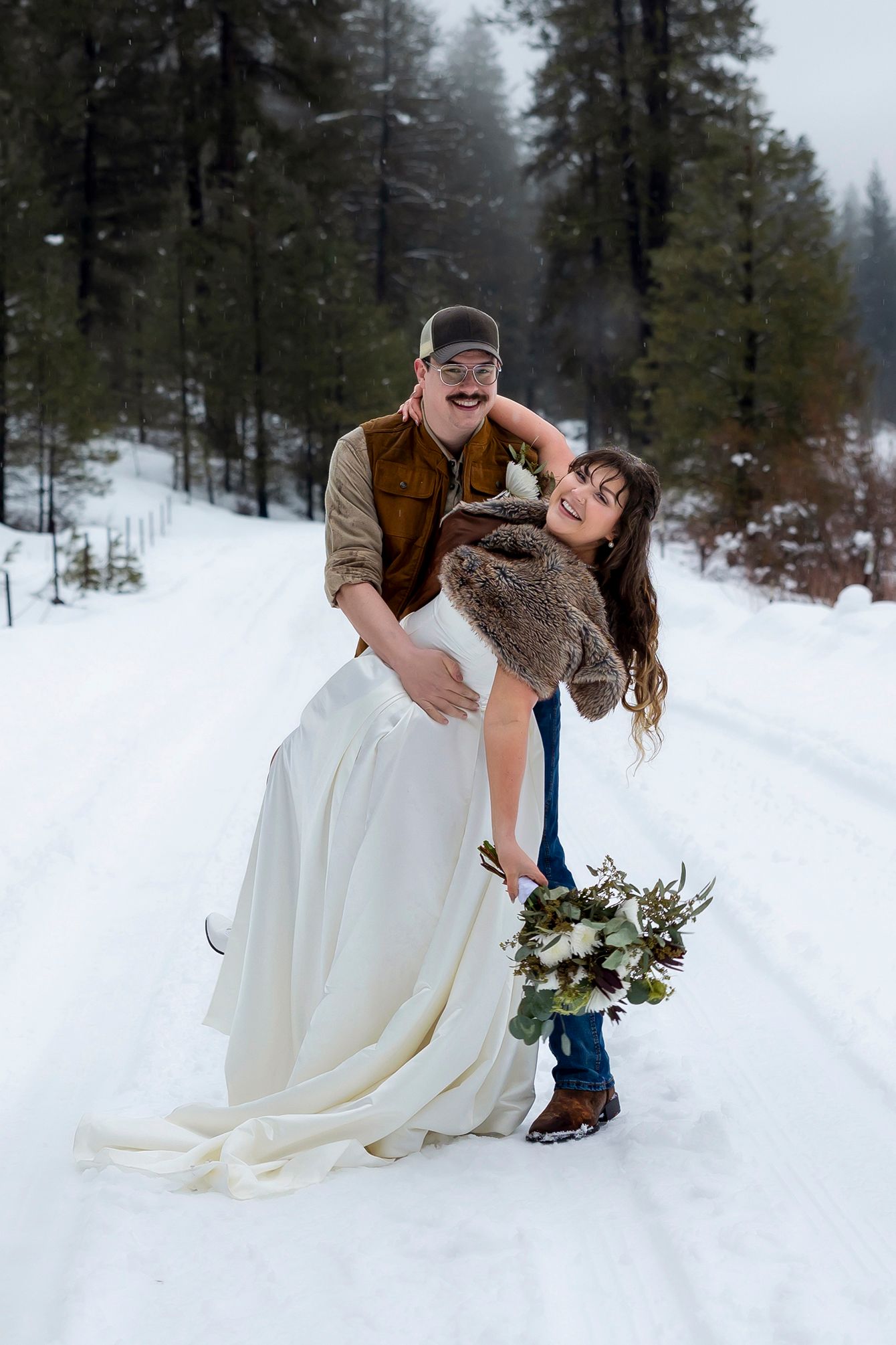 groom dipping bride in the snow