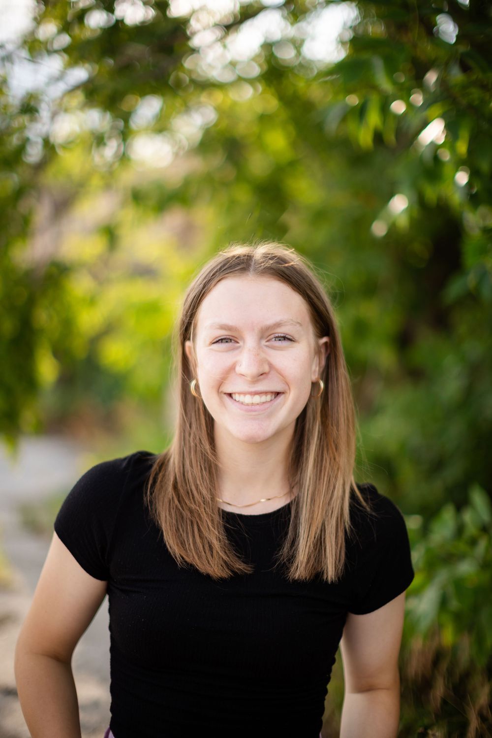 Three portrait photos show someone wearing a black t-shirt outdoors against a green leafy background.