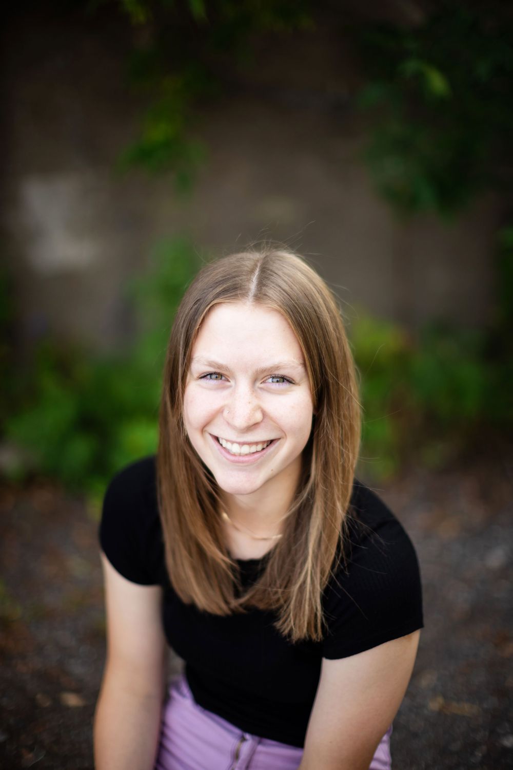 A portrait series showing different angles and expressions of someone in a black shirt with shoulder-length brown hair.