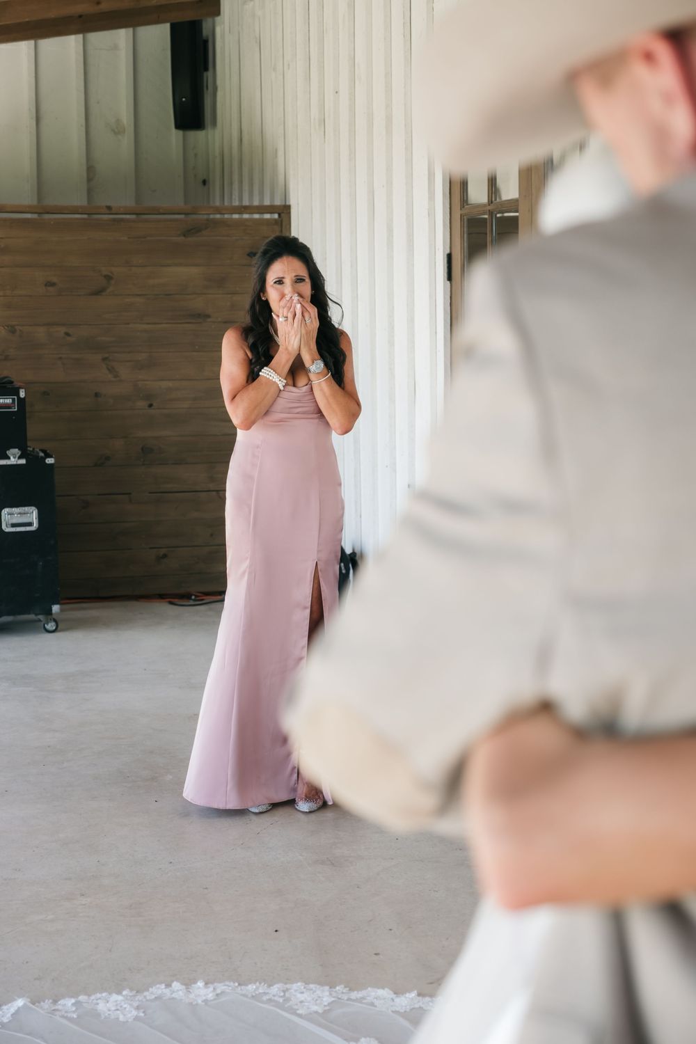 Couple during first dance reveal at a wedding reception where the bride wears a pastel pink gown.