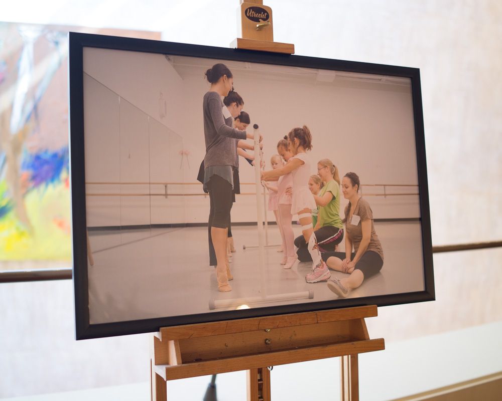 Dance workshop or class participants gathered on a studio floor.