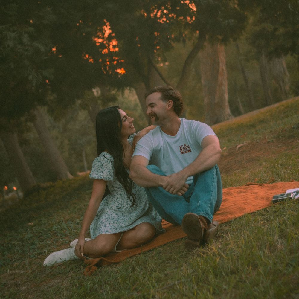 Photography of couple sitting in the park