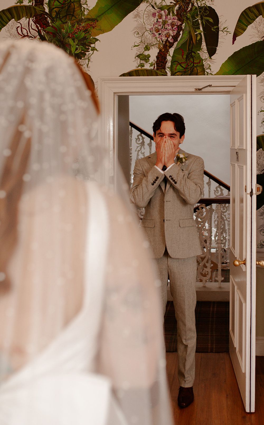 First look wedding moment captured in an elegant indoor setting.