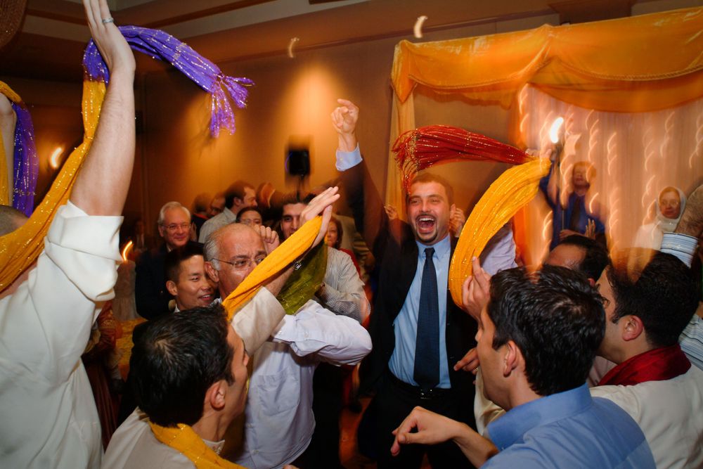 Energetic dance party celebration with orange and purple decorations.